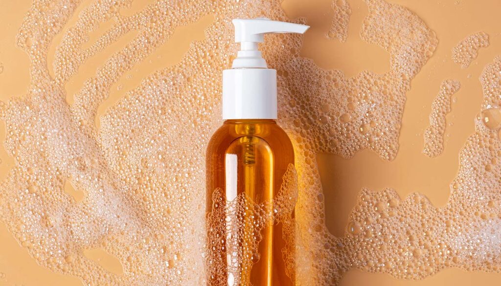 Hydrophilic cleansing oil and foam on a soft beige background. 
