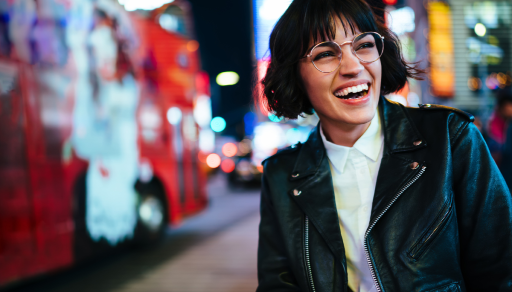 Smiling woman wearing leather jacket outside