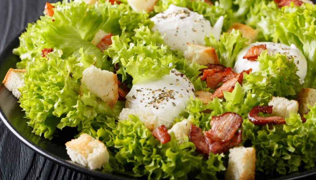 French Salade Lyonnaise With Bacon and a Poached Egg