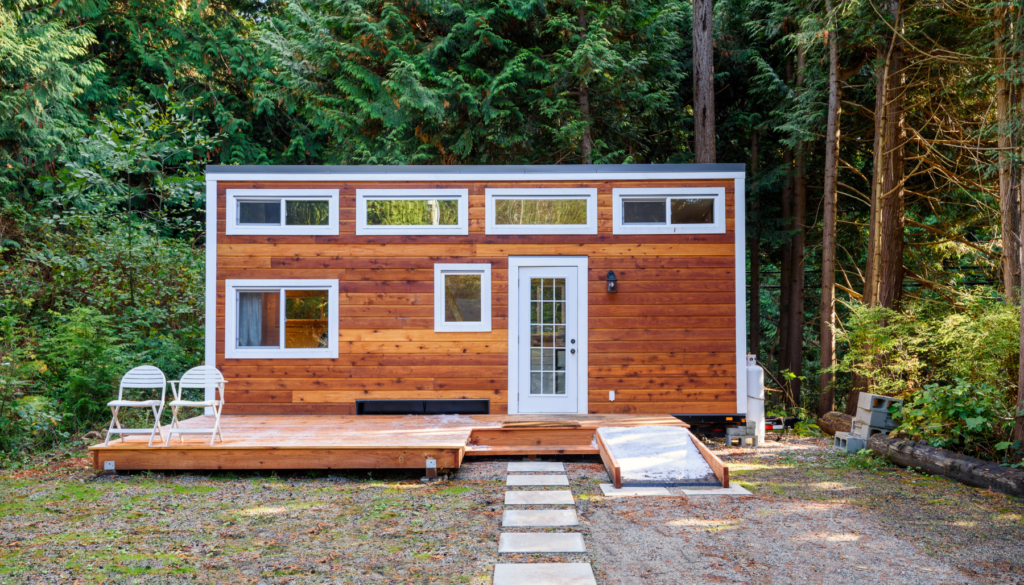 Tiny home with path at edge of forest