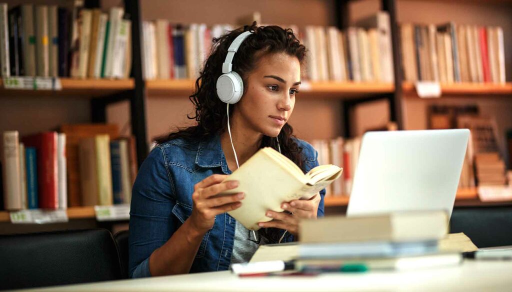 woman learning on laptop in library