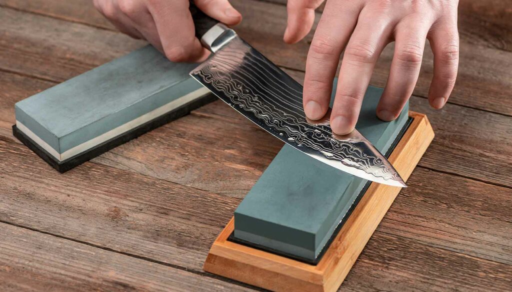 sharpening a kitchen knife on a whetstone