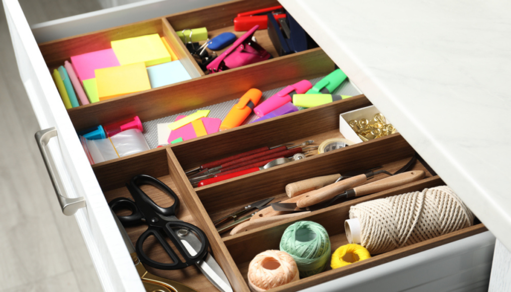Open drawer with organizer containing various supplies