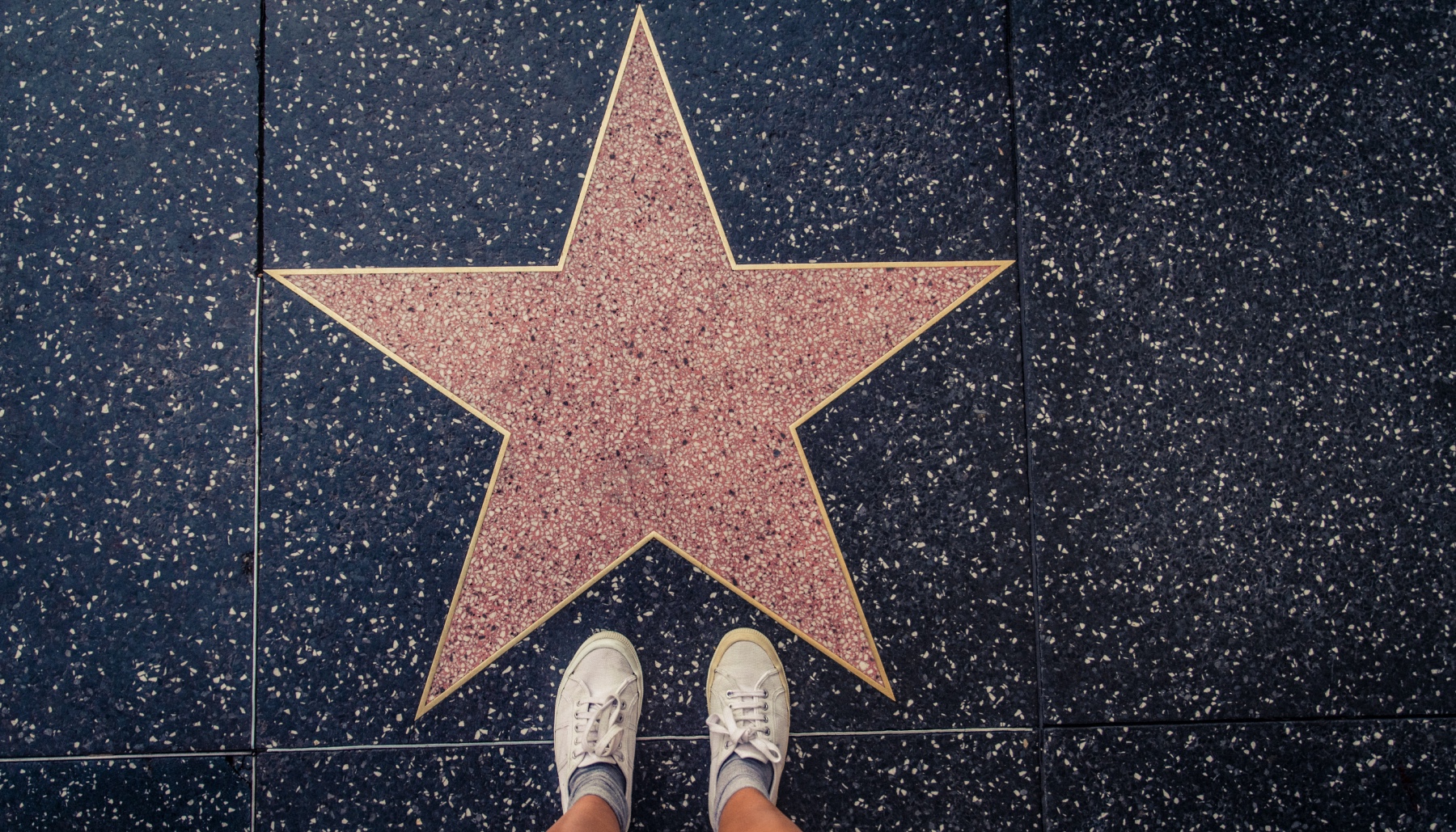 shoes standing at a Hollywood walk of fame star