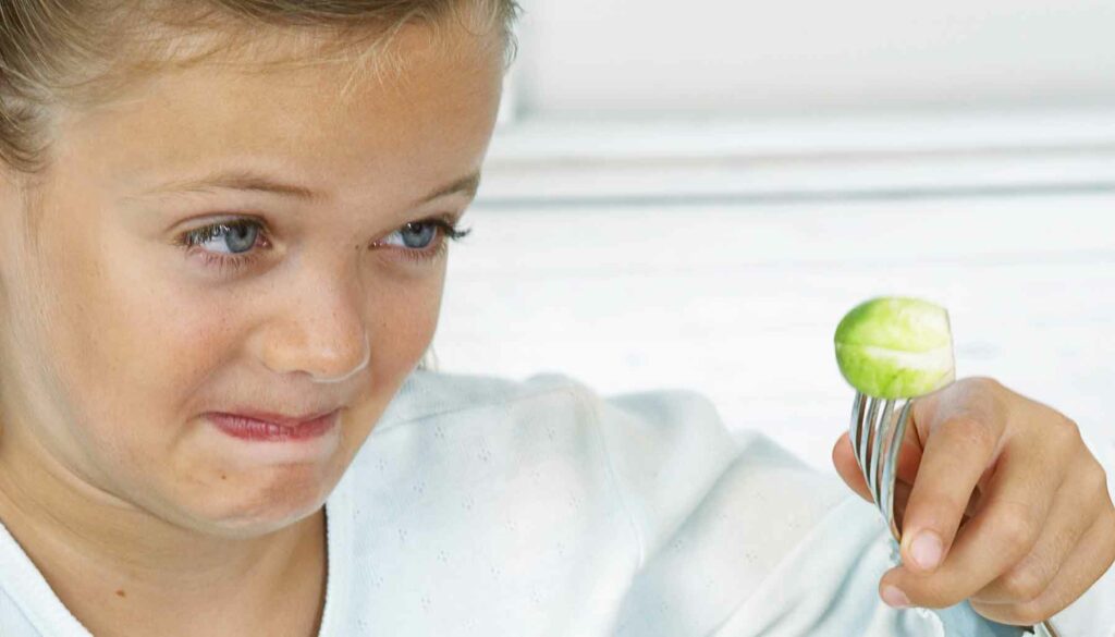 unhappy kid with brussels sprouts