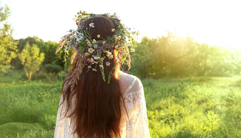 woman with flower crown standing out in a field