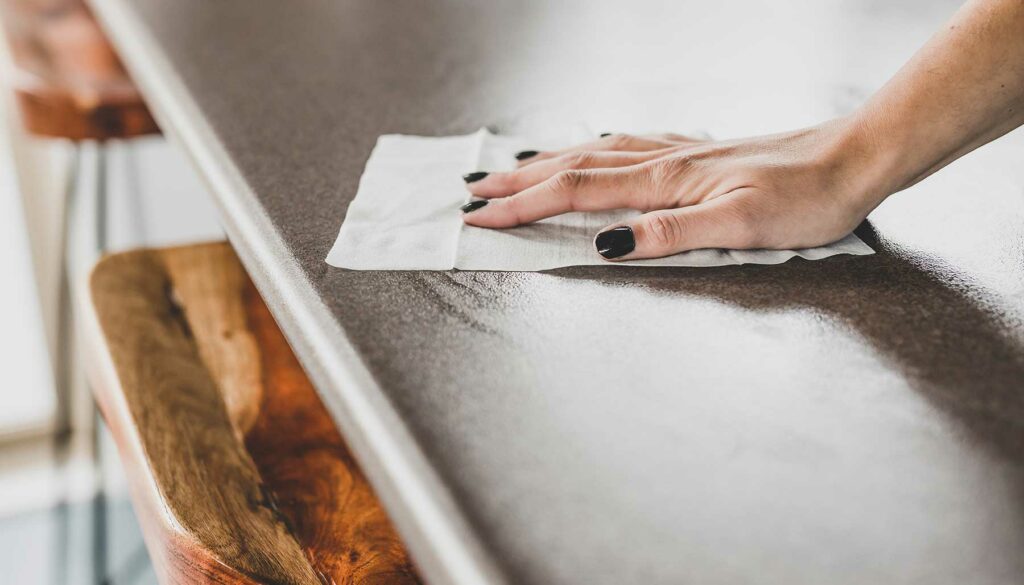 wiping and sanitizing a stainless steel counter top, cleaning with disinfecting wipes