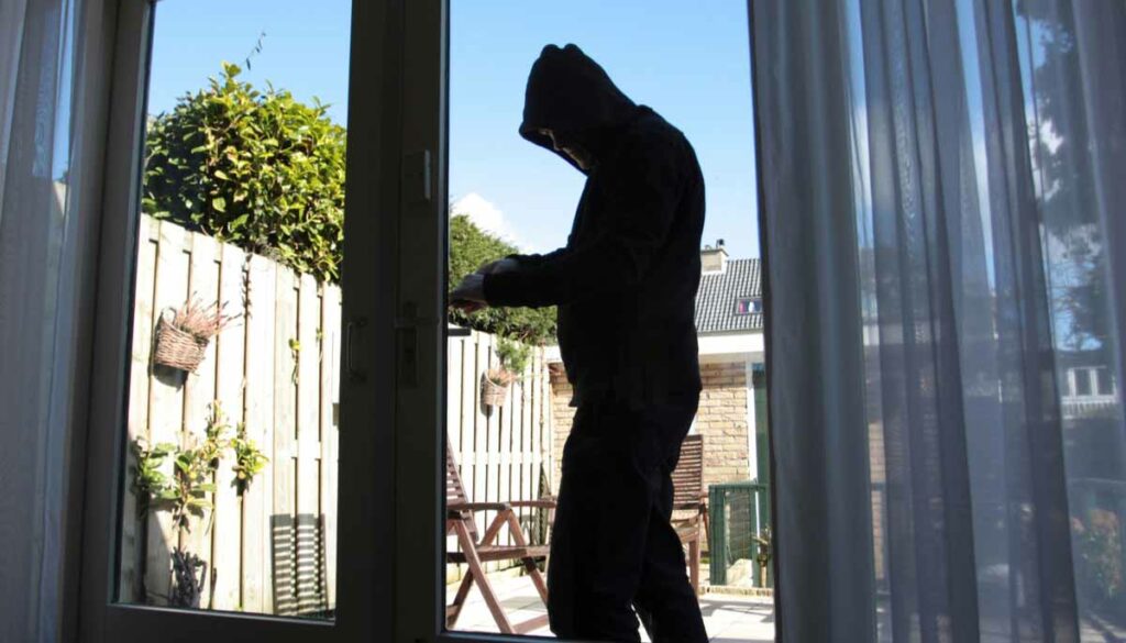 Burglar Breaking into Home through sliding back door