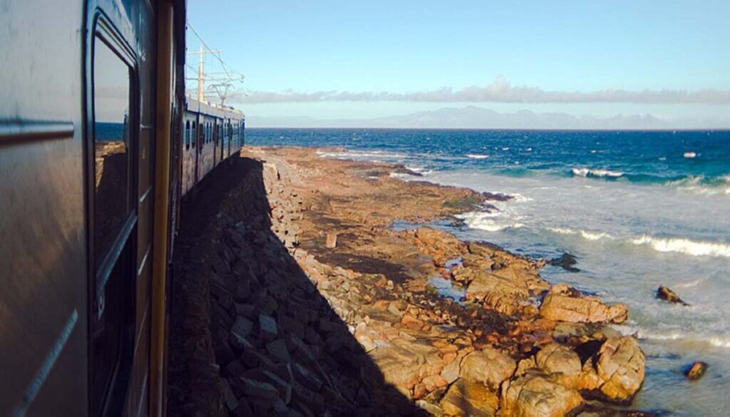 famous blue train passing shoreline of Cape Town overlooking Indian Ocean