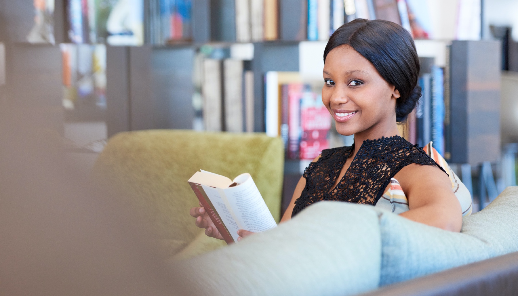 woman reading a book and smiling