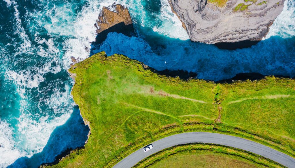 Top-down aerial view over the Irish rugged coastline at Kilkee Cliffs, Co Clare. Epic Irish Seascape along the wild Atlantic way.The natural beauty of the cliff edge and the blue Atlantic ocean.