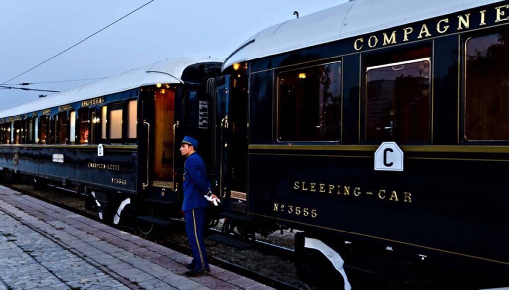 legendary orient express with train attendant standing at doors