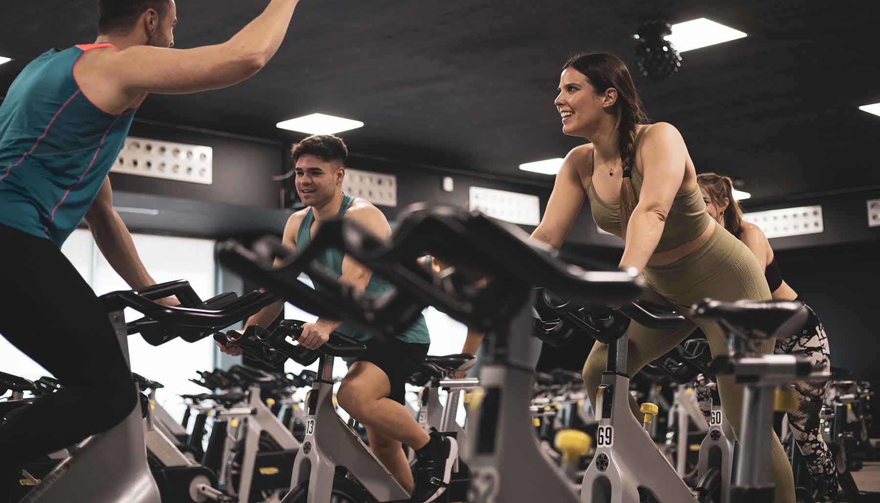 People in a gym on stationary bikes, spin class
