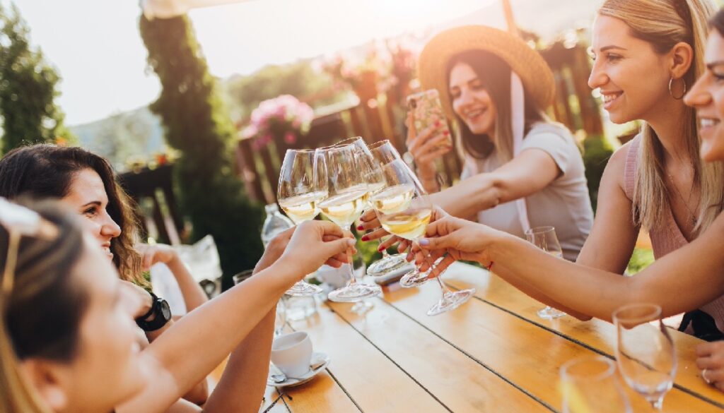 friends clinking glasses at brunch